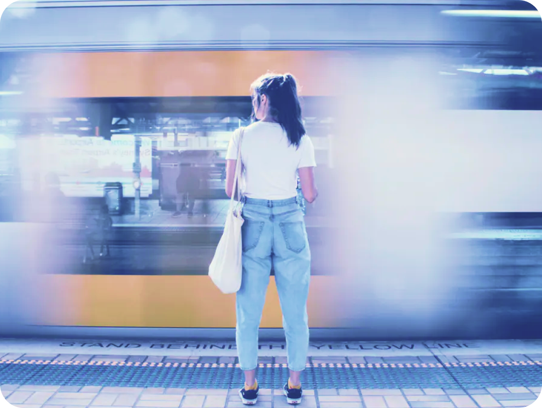 Woman standing in front of passing train