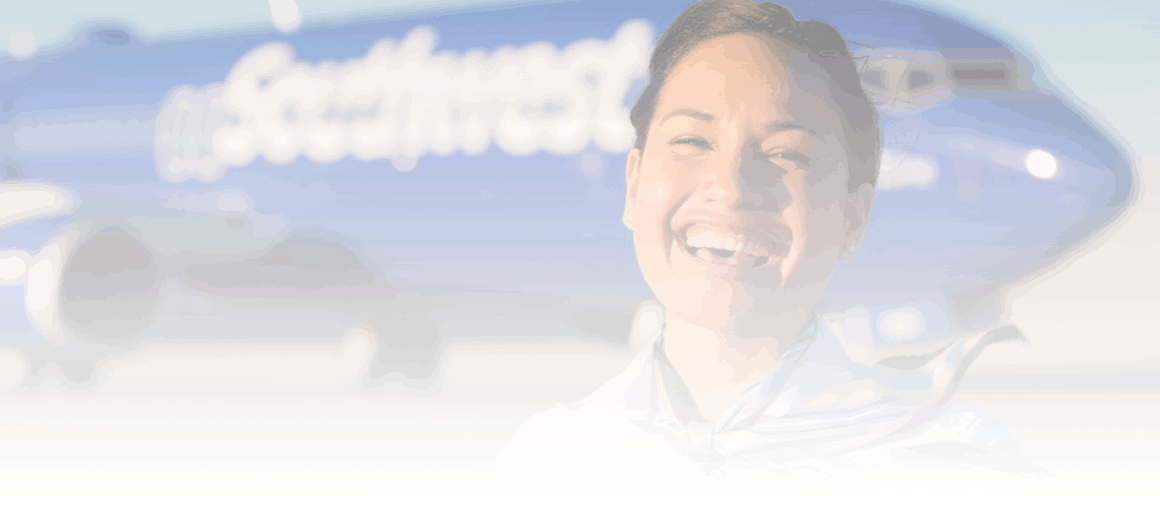 woman smiling in front of plane