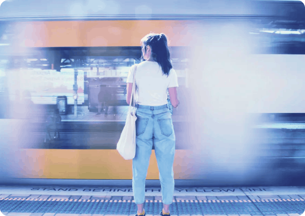 Woman standing in front of moving train